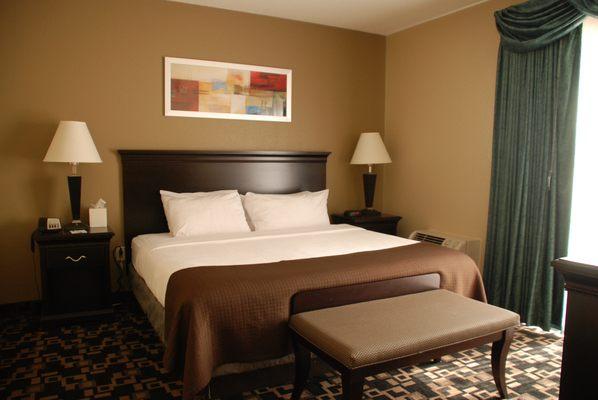 Corner Suite: King Bed in Separate Bedroom with glass French doors, Pullout Sofa in sitting area with Jacuzzi Whirlpool.