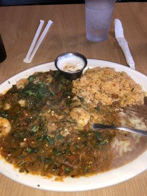 Camerone Rancheros with rice, beans and a side of sour cream.