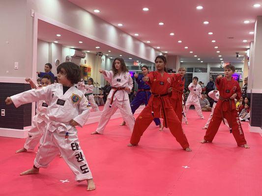 A group of students punching during a belt promotion test