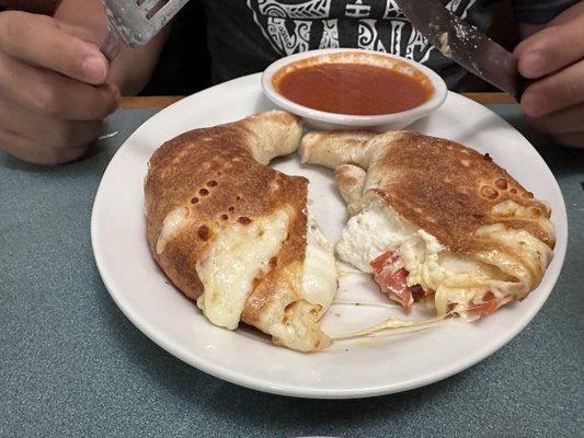 Pepperoni Calzone (Calzone filled with pepperoni, ricotta, mozzarella cheese served with a side of marinara sauce)