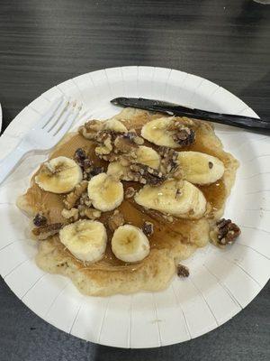 Pancake machine, peanut butter, sliced banana, syrup and walnuts.