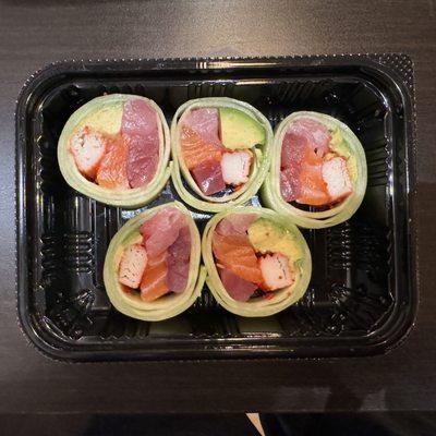 Dragon Sushi's enjoyable Naruto rice-free roll of Salmon, Tuna, Crab stick, Avocado, & Tobiko wrapped in cucumber with Ponzu Sauce