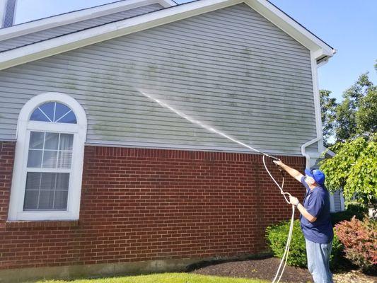 Soft washing removing algae