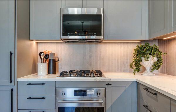 Kitchen with built in refrigerator and range oven at Le Noble Apartments in La Brea, Los Angeles California.