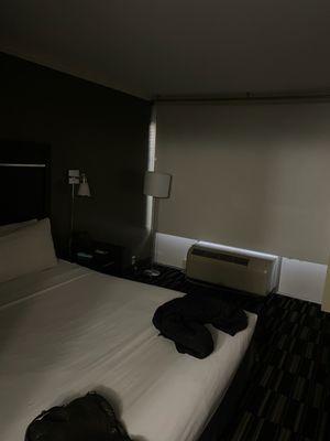 dark hotel room with lights not working.  No bedding except 1 sheet.