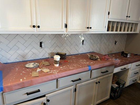 Herringbone backsplash installation