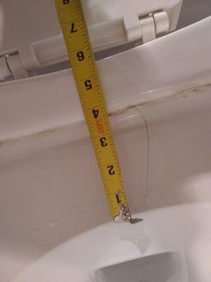 Measurement of crack in toilet bowl.