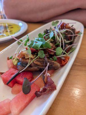 The best quail we've had in 28 countries! It's cooked perfectly and comes with the best of summer - watermelon, pistachios and micro greens.