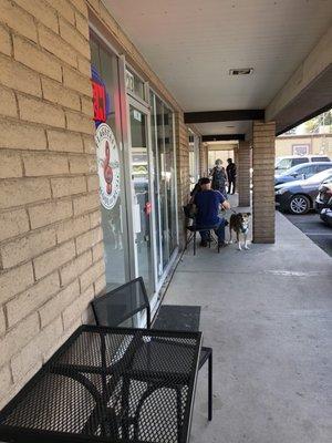 Three outdoor tables with chairs.