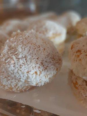 Orange donut dipped in orange syrup, topped with tender coconut. Experience this.