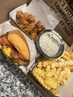 Shake shack burger w/ bacon, fried chicken bites, truffle fries. (The truffle sauce is added on the side)