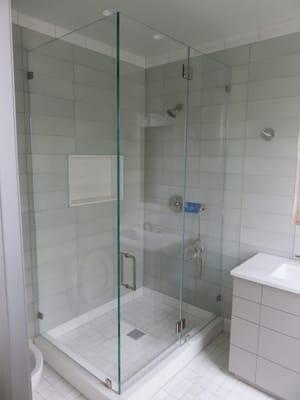 Frameless shower enclosure