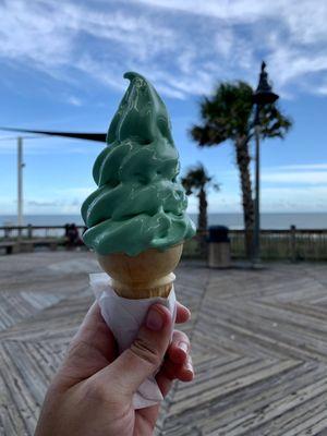 Small pistachio soft serve ice cream cone