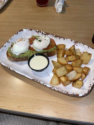 Avocado Benedict with side of potatoes