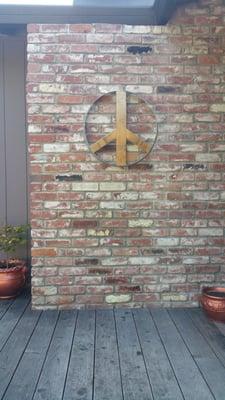 A handmade Peace Sign from wine barrel pieces from a local artist. Don't you love it!