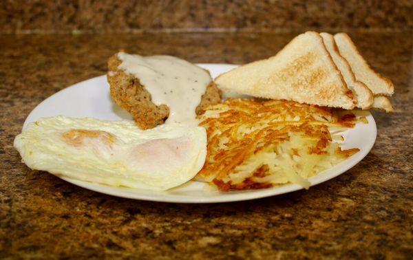 Country Fried Steak topped with White Gravy, Two eggs(your choice of how they are cooked), Hash Browns and Toast.