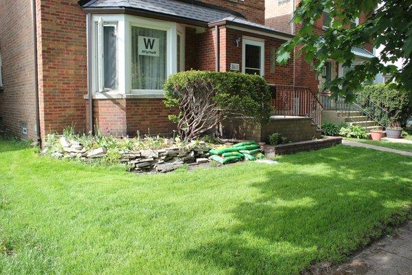 Before Landscaping:
 Objective: Remove grass to re-sod, remove stone work and old evergreen to re-landscape complete yard.