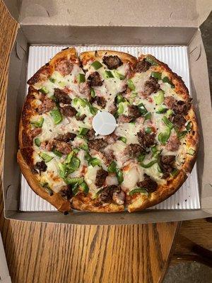 Pizza with sausage, homemade meatballs, onions and green peppers