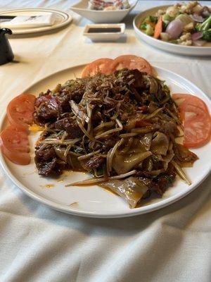 Stir fry beef and wide noodles. Odd with the tomato's and very bland