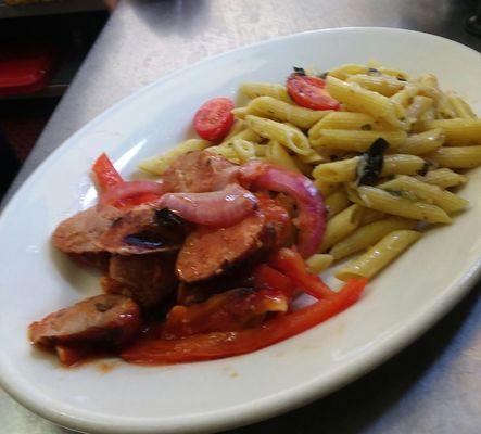 Penne pasta with sausages with onions and peppers