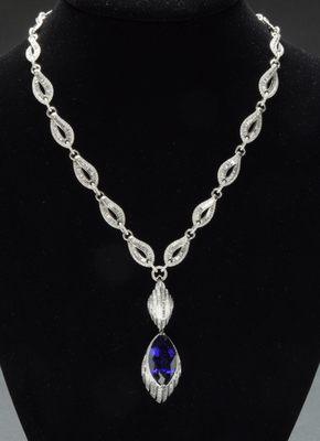 Tanzanite Pendant 30.56ct 18K White Gold 17.25g 37 round diamonds 0.41 tcw 261 baguette diamonds 5.17 tcw