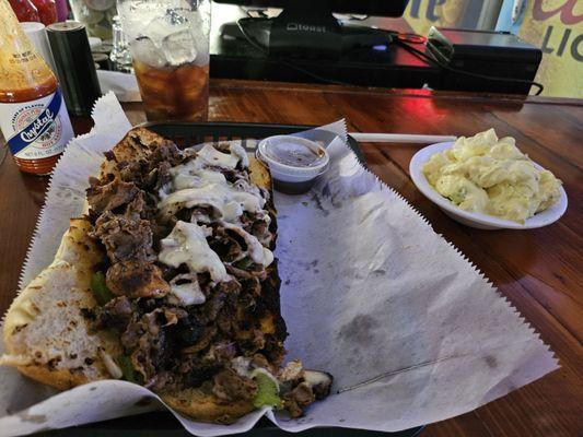 Philly cheesesteak and tater salad.