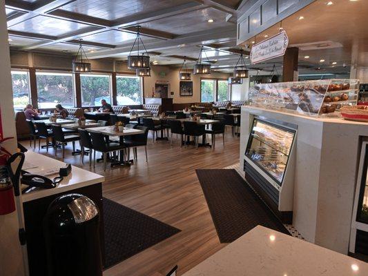 View of the main dining area as you stand at the edge of the cashier's counter. Bakery is straight in front of you to the right