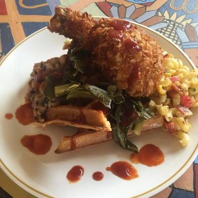 Austin plate. Corn flake fried chicken, waffles, collard greens, black eyed peas, honey bacon mac, house BBQ sauce, and pickled cherry toms.