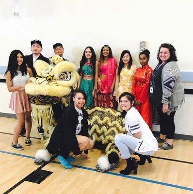 Golden lion posing with enthusiastic students post-peformance at De La Salle North Catholic High School. White Lotus Dragon & Lion Dance.