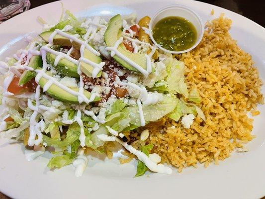 Beef & chicken Taquitos underneath the salad.