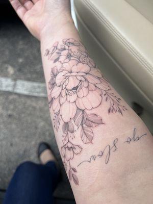 Floral tattoo and script