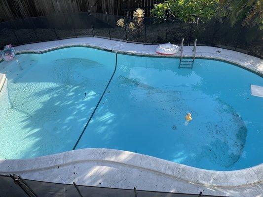 These are photos of our pool spread out between months of service showing how they never cleaned the filter sand out of the pool.