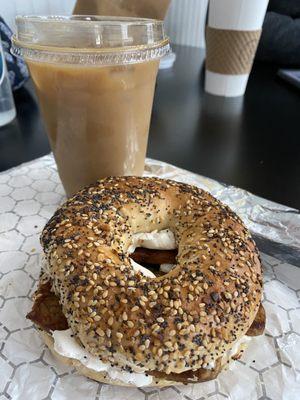 The real vegan - everything bagel with vegan cheese and tempeh bacon. Iced Oatmilk latte with caramel syrup