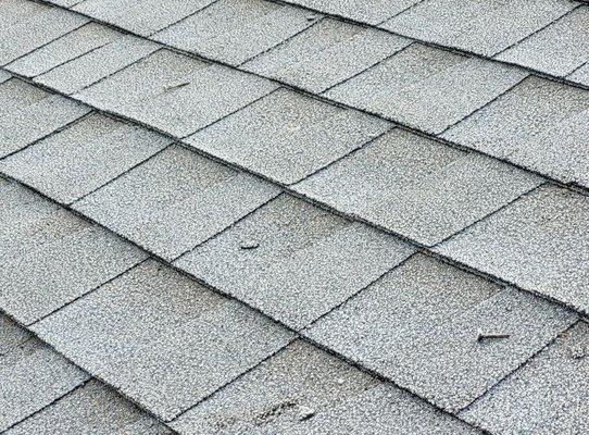 The finished roof and you can see loose nails and shingle debris