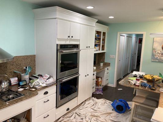 Cabinet Refinished from Natural Oak Wood to a Factory Finish White - Installed Crown Molding - Replaced all Cabinet Hinges and Door Handles