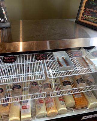 Deli case with meat and cheese to slice by the pound !