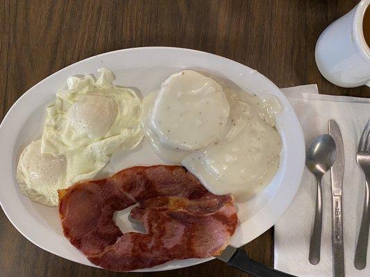 Breakfast plate with country ham and gravy biscuit