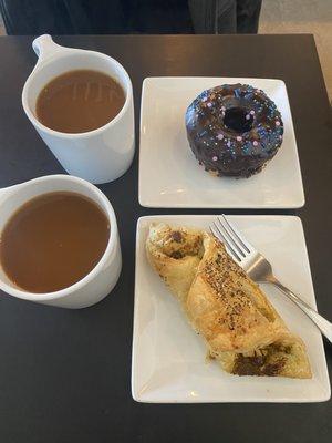 Regular coffee with oat milk, donut, and veggie pastry