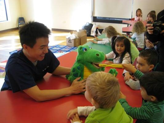 Dr. Chen showing the kids how to brush their teeth.