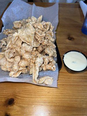 Lemon pepper pork rinds with queso dip