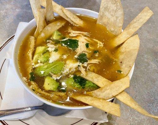 Sopa de tortilla / Chicken tortilla soup. They make it differently with no tomato base used. Still tasty.