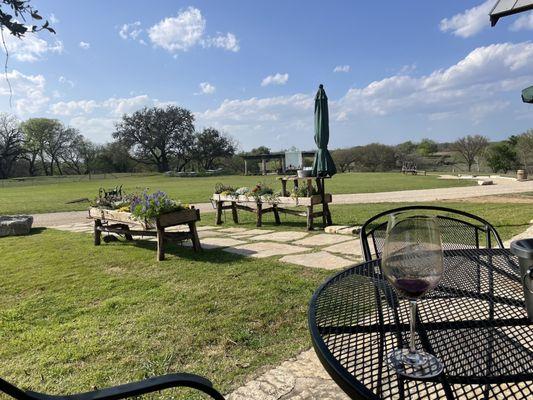 View from tasting room patio toward large pergola and river bank.