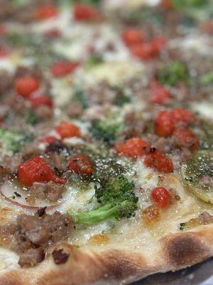 Finely sliced potatoes, Italian sausage, broccoli, and petite sweet peppers with a macadamia nut and basil pesto