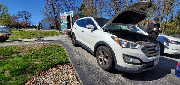 Zippity replacing a battery for a customer in their driveway.