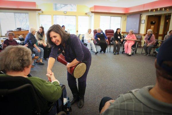 CEO Jodi Winnwalker leading group drumming at a local day program for elders.