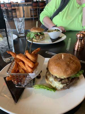 Mushroom Swiss Burgers - one with sweet potato fries and the other with Brussel sprouts