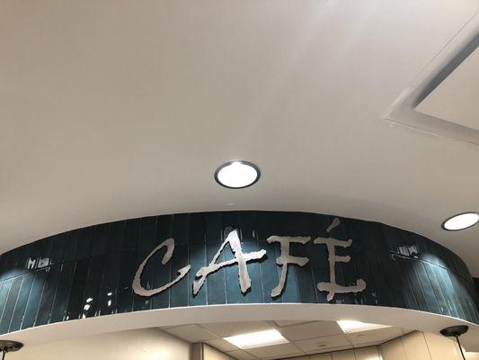 Glowing Cafe sign above