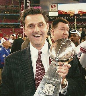 Dr. Ken Ermann hold the Lambardi Trophy with NY Giants as the team Chiropractor