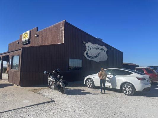 Brown building on the outside. Gravel Parking lot