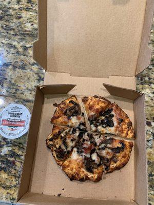 Tiny burnt personal pizza. Note pizza to box ratio.